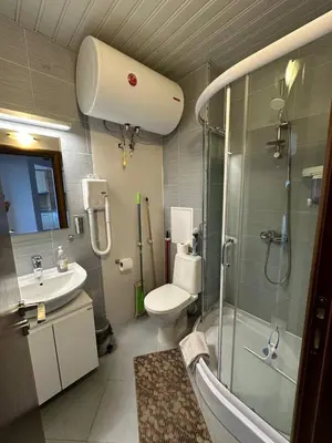 a bathroom with a shower and a toilet and a sink at Apartment in Belvedere Holiday Club 550 m from ski lift in Bansko