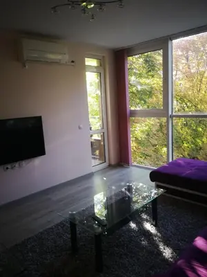 a living room with a couch and a glass coffee table at Луксозен апартамент в идеалния център на град Сандански in Sandanski