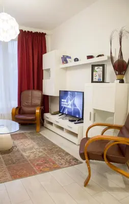 a living room with a flat screen tv and chairs at Luxury suite near NDK and Viotosha blvd in Sofia