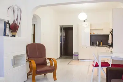 a living room with a chair and a table at Luxury suite near NDK and Viotosha blvd in Sofia