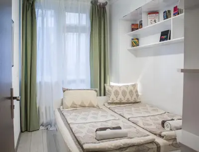 a small bedroom with a bed and a window at Luxury suite near NDK and Viotosha blvd in Sofia