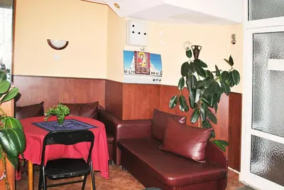 a living room with a couch and a table and a chair at Family hotel Zora in Sofia