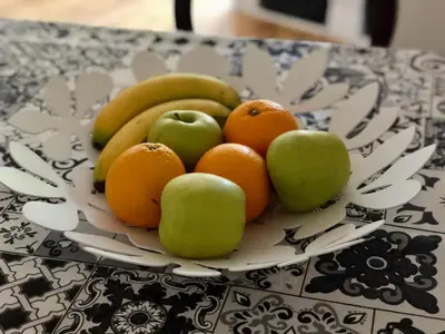 a plate of fruit sitting on a table at Spacious modern vintage flat in the heart of Sofia in Sofia