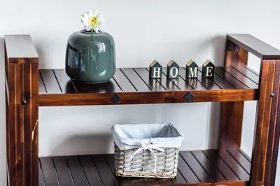 a wooden shelf with a vase and a basket on it at Gladstone suites in Plovdiv