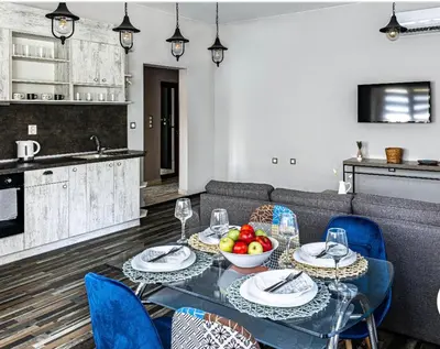 a living room with a table with a bowl of fruit at Gladstone suites in Plovdiv