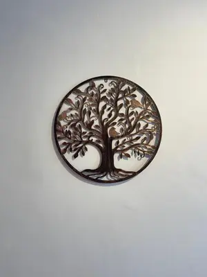 a metal plate with a tree on a wall at Dara House in Plovdiv