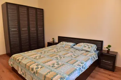 a bedroom with a bed and two night stands at Cedar Lodge in Bansko