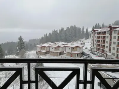 a view from a balcony of a resort in the snow at Apartment Viki Pamporovo in Pamporovo