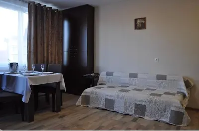 a bedroom with a table and a bed and a window at ComfortApartment IGLIKA 2 in Borovets