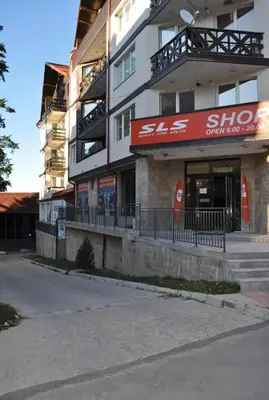 a building with a shop on the side of it at ComfortApartment IGLIKA 2 in Borovets