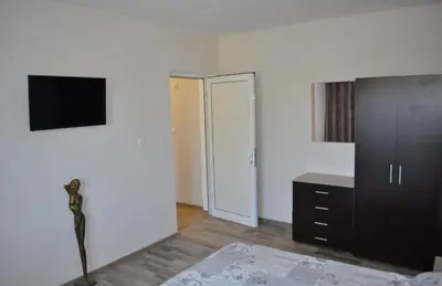 a bedroom with a bed and a tv on a wall at ComfortApartment IGLIKA 2 in Borovets