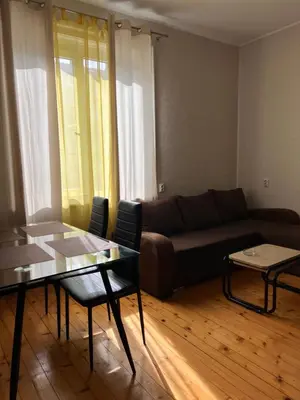 a living room with a couch and a table at Serdika station, bright and cozy apartment in Sofia