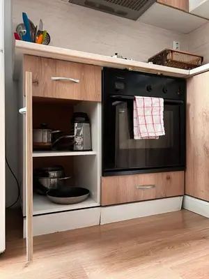 a kitchen with a black microwave in a cabinet at Serdika station, bright and cozy apartment in Sofia
