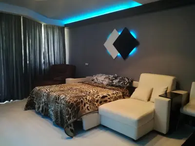 a bedroom with a bed and a couch and a chair at Apartment 33 in Hotel Iceberg in Borovets
