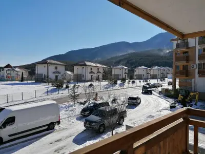 a view from the balcony of a apartment complex in the snow at Luxury apartments in St. John Park in Bansko