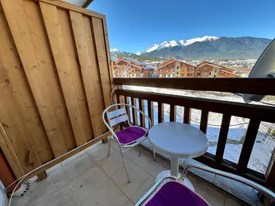 a table and chairs on a balcony with a view at Luxury apartments in St. John Park in Bansko
