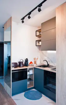 a kitchen with blue cabinets and a blue rug at Apartment City View in Sofia