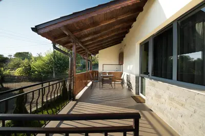 a balcony with a bench and a table on it at Къща за гости Елица in Starchevo