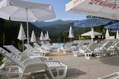 a group of chairs and umbrellas on a patio at Constantzia Balneohotel in Kostenets Village