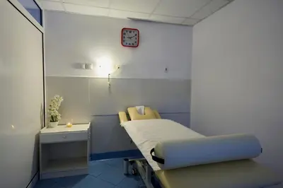 a hospital room with a bed and a table at Constantzia Balneohotel in Kostenets Village