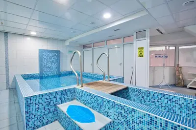 a large swimming pool with a blue tiled floor at Constantzia Balneohotel in Kostenets Village