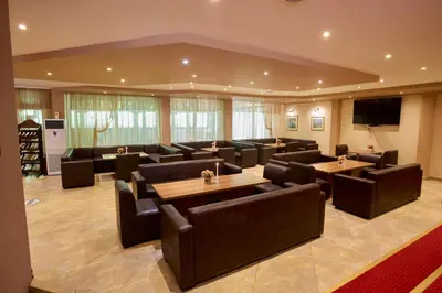 a large waiting room with couches and tables at Constantzia Balneohotel in Kostenets Village