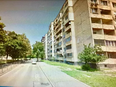 an empty street in front of an apartment building at Faith,Hope and Love apartment in Sofia