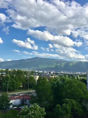 a view of a city with mountains in the background at Faith,Hope and Love apartment in Sofia
