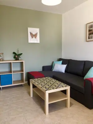 a living room with a couch and a coffee table at Faith,Hope and Love apartment in Sofia