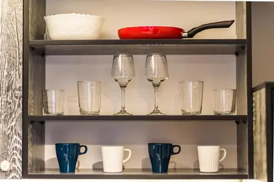 a shelf with glasses and cups on it at The Red Roof House in Plovdiv