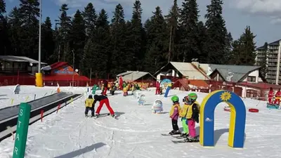 a group of children on skis in the snow at Iglika 2, A6 in Borovets