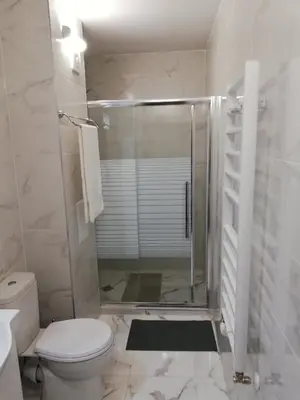 a bathroom with a shower with a toilet and a sink at Iglika 2, A6 in Borovets
