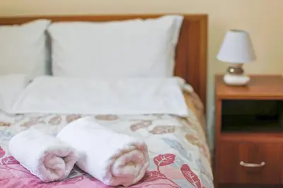 a bed with two towels on top of it at BanskoSuperSki in Bansko