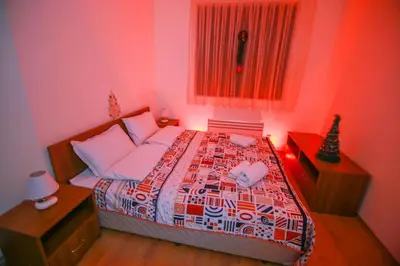 a red bedroom with a bed and a window at BanskoSuperSki in Bansko