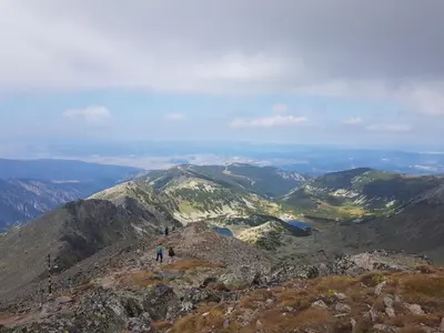 two people standing on the top of a mountain at Flora Apartments TMF in Borovets