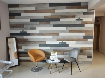 a wall made out of wood with two chairs and a table at Alexander Hotel in Asenovgrad