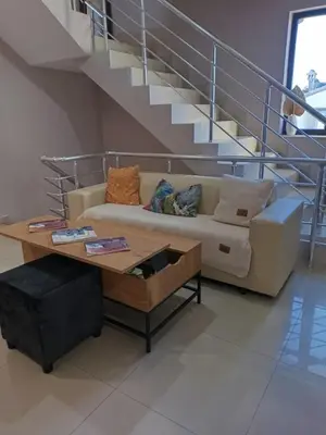 a living room with a couch and a coffee table at Alexander Hotel in Asenovgrad