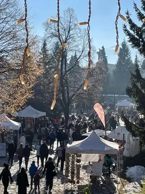 a crowd of people walking around a market with tents at Edelweiss Central Hotel in Bansko