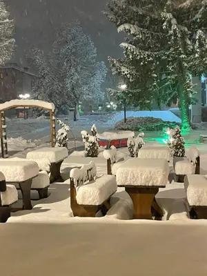 a group of benches covered in snow in a park at Edelweiss Central Hotel in Bansko