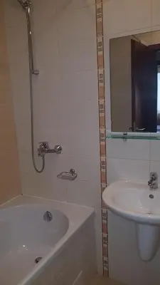 a bathroom with a sink and a bath tub and a sink at Borovets Gardens Apartments TMF in Borovets
