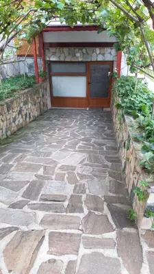 a stone walkway leading to a garage at Medi Guest House in Sapareva Banya