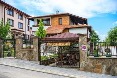 a building with a gate with graffiti on it at Medi Guest House in Sapareva Banya