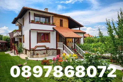 a house with a sign in front of it at Medi Guest House in Sapareva Banya