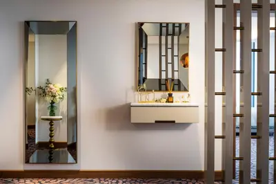 a bathroom with a sink and a mirror at Grand Hotel Millennium Sofia in Sofia
