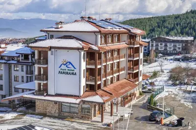 a building with a sign on the side of it at Park Hotel Panorama in Bansko
