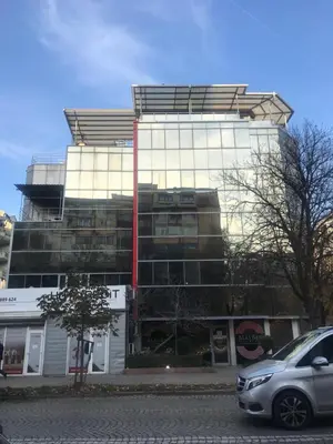 a building with a car parked in front of it at Lilia 5 Self-Check in apartment in Sofia