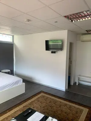 a room with a bed and a tv on a wall at Lilia 5 Self-Check in apartment in Sofia