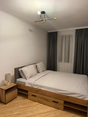 a bedroom with a bed and a ceiling fan at Пампорово , Манастира 3 in Pamporovo