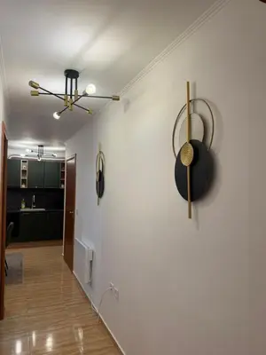 a hallway with white walls and a ceiling fan at Пампорово , Манастира 3 in Pamporovo