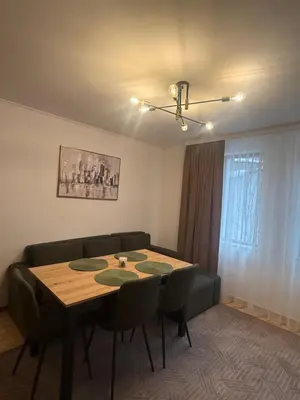 a dining room with a table and a couch at Пампорово , Манастира 3 in Pamporovo